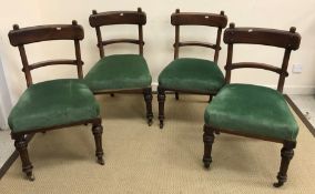A set of four Victorian bar back dining chairs with green upholstered seats and stud style