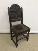 A 17th Century and later carved oak chair, the back with foliate oak leaf and acorn decoration,
