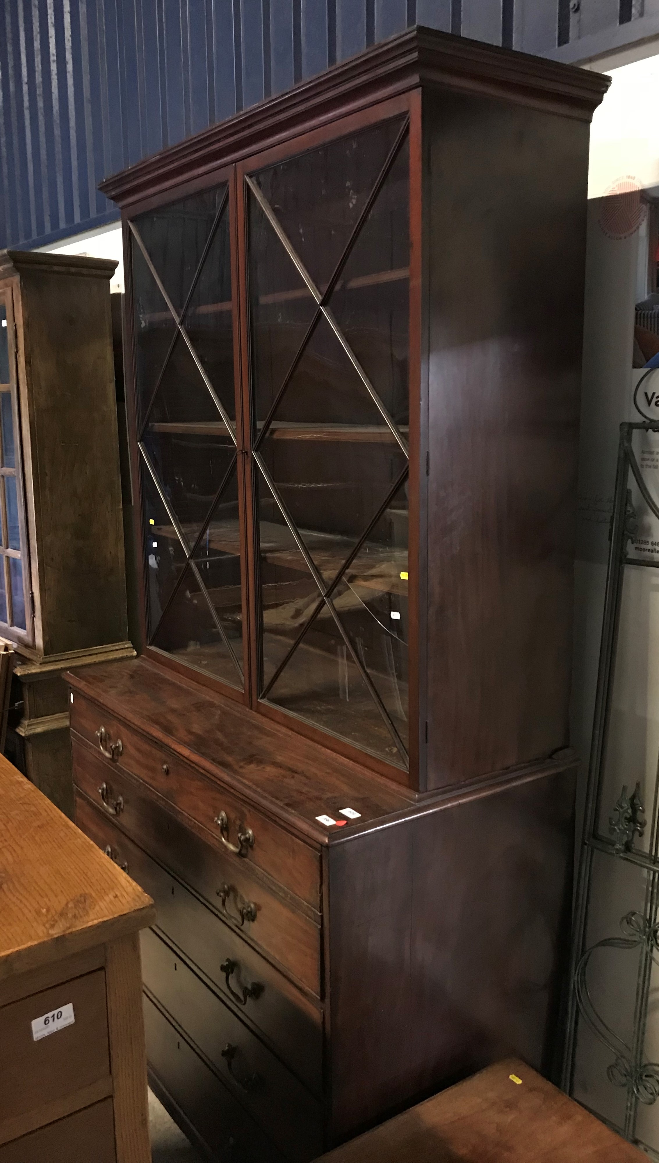 A George III mahogany secretaire bookcase, the two glazed doors enclosing adjustable shelves,