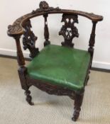 A 19th Century carved walnut corner chair with green upholstered seat,