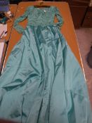 A 1960s Camilla Middleton aquamarine satin evening gown with lace overlay to bodice and sleeves