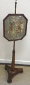 A Victorian mahogany pole screen with silkwork floral decorated panel,