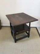 A 17th Century and later oak monk's chair, the associated three plank top with cleated ends,