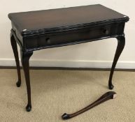 A modern mahogany fold over card table i