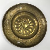 An 18th Century brass alms dish with emb