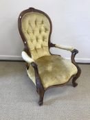 A Victorian spoon back salon armchair wi