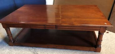 A modern cherry wood coffee table, the r