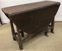 An oak oval gate leg drop leaf dining ta