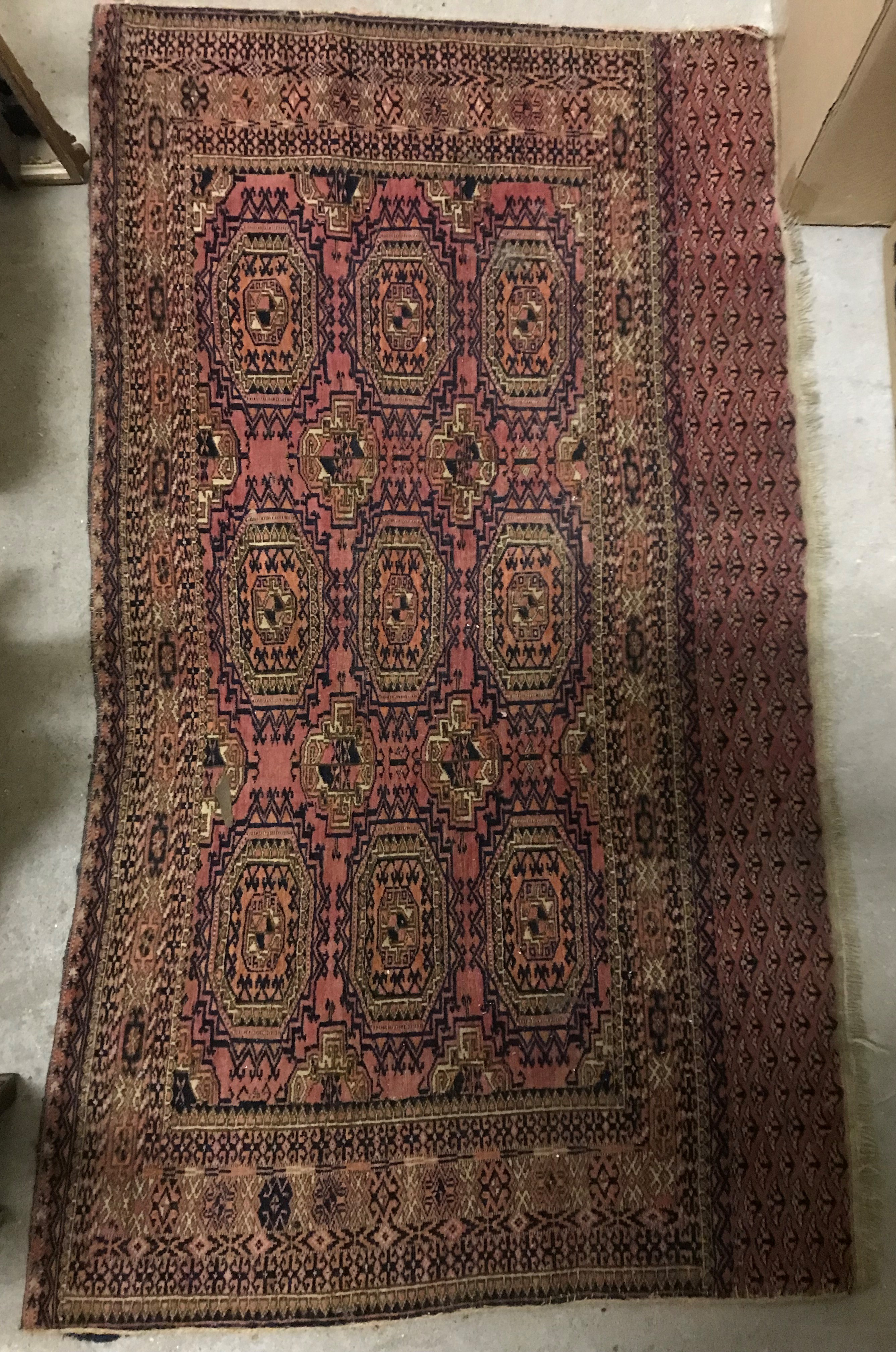 A vintage Bokhara rug, the central panel