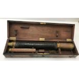 A mahogany cased brass two draw telescop