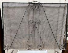 A wrought iron framed wirework spark gua