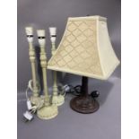 A set of three cream enamelled metal table lamps with foliate collars, 45.5cm together with a bronze