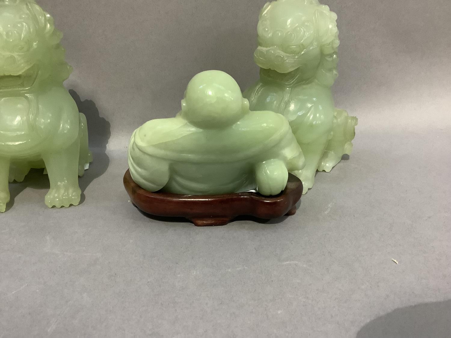 A pair of Chinese jade effect lion dogs together with a carving of Buddha in a jade like hard stone, - Image 3 of 3