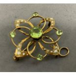 An Edward VII peridot and seed pearl pendant/brooch in 9ct gold, the circular facetted peridot