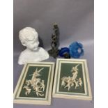 A pair of green and cream ceramic plaques moulded in high relief with an angel playing a lute as