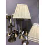 A set of four gilt metal table lamps on domed bases, 46cm high together with a candlestick style