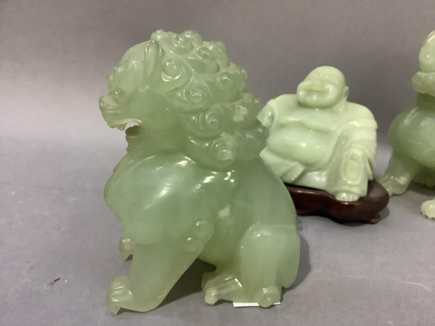 A pair of Chinese jade effect lion dogs together with a carving of Buddha in a jade like hard stone, - Image 2 of 3