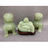 A pair of Chinese jade effect lion dogs together with a carving of Buddha in a jade like hard stone,