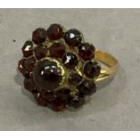 A Bohemian garnet cluster ring, the rose and cabochon cut stones collet set with a circular