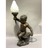 A bronze effect metal lamp in the form of a cherub holding aloft a torchere measuring 95cm