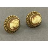 A pair of shell cameo ear studs in 9ct gold, collet set with an oval female portrait on post and