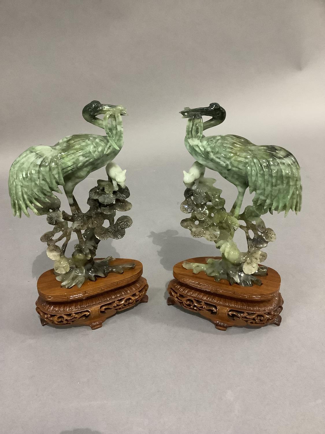 A pair of Chinese polished hardstone figures of an egret and cat in the branches of a pine tree, - Image 2 of 4