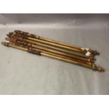 A set of six Victorian stained curtain poles with turned finials, rings and each with a pair of