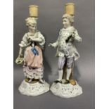 A pair of 19th century Sitzendorf china figure candlesticks modelled as a beau and companion on