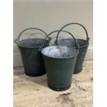 Three green painted buckets with swing handles, various sizes, two with riveted seams and one