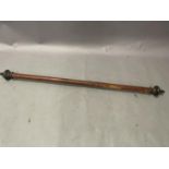 A Victorian mahogany stained curtain pole with ebonised finials