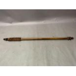 A Victorian mahogany stained curtain pole with rings and turned finials