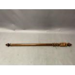 A Victorian hardwood curtain pole with turned finials, rings and pair of brass brackets, 202cm