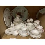 A quantity of Victorian and later tea cups and saucers, two circular china trays, rosebud tea