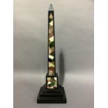 A 19th century Grand Tour design black pietra dura obelisk inlaid in the Black Ashford manner with