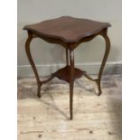 An Edwardian mahogany window table of shaped square outline with undertier