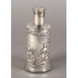 A George V silver sleeved glass scent bottle, embossed with country lasses listening to a young