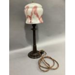 A 1930s brown Bakelite table lamp with tapered column and circular dished base with marbled glass