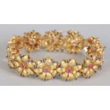 A RUBY AND SAPPHIRE FLORAL CLUSTER BRACELET in 18ct gold, c.1965, the circular faceted stones claw