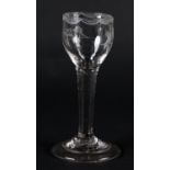 A MID 18TH CENTURY WINE GLASS, the ogee bowl engraved with flowers below a lambrequin border to