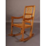 THOMPSON OF KILBURN 'MOUSEMAN', an oak rocking chair having a lattice panel to the back, open arms