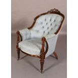 A VICTORIAN MAHOGANY ARMCHAIR having a moulded encircling frame with pierced scrolled cresting, pale