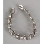 A DIAMOND BRACELET IN PLATINUM circa 1950, each fetter link grain set with two brilliant cut