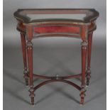 A VICTORIAN MAHOGANY BIJOUTERIE TABLE with gilt metal mounts, concave front, serpentine glazed
