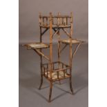AN AESTHETIC MOVEMENT BAMBOO FRAMED PLANT STAND of four tiers, inset with four tiles including two