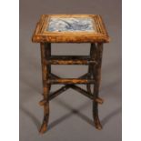 AN AESTHETIC MOVEMENT BAMBOO FRAMED OCCASIONAL TABLE, the top inset with a blue and white tile