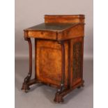 A VICTORIAN FIGURED WALNUT DAVENPORT, having a raised superstructure with ink well, pen slide and
