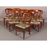 A HARLEQUIN SET OF THIRTEEN MAHOGANY BALLOON BACK DINING CHAIRS, upholstered seats and on turned