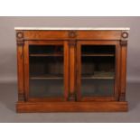 A VICTORIAN ROSEWOOD AND MARBLE TOPPED BOOKCASE, having two drawers to the apron above two glazed
