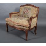 A LATE 19TH CENTURY FRENCH BEECH FAUTEUIL, having a late moulded encircling frame, with flower
