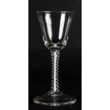 A MID 18TH CENTURY WINE GLASS, rounded funnel bowl on an opaque single twist around a solid